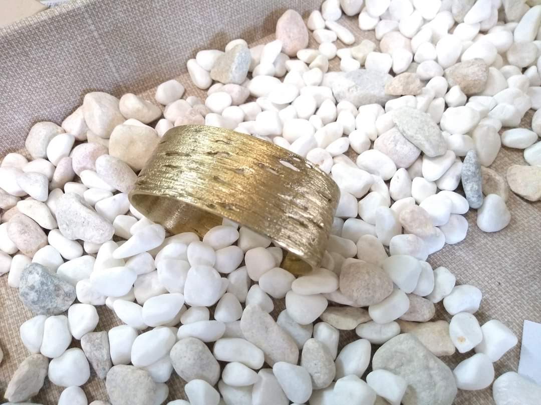 Birch bark striations and horizontal pores (lenticels) are visible on this finely crafted bronze bangle cast from nature