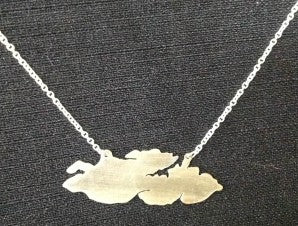  silhouette of Howe Island, 1 inch long sterling silver with chain attached from 2 points near middle