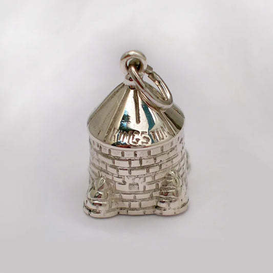 Close up view from above shiny silver Martello Tower pendant showing brick detail and Kingston stamped on the roof, with loop for chain attachment