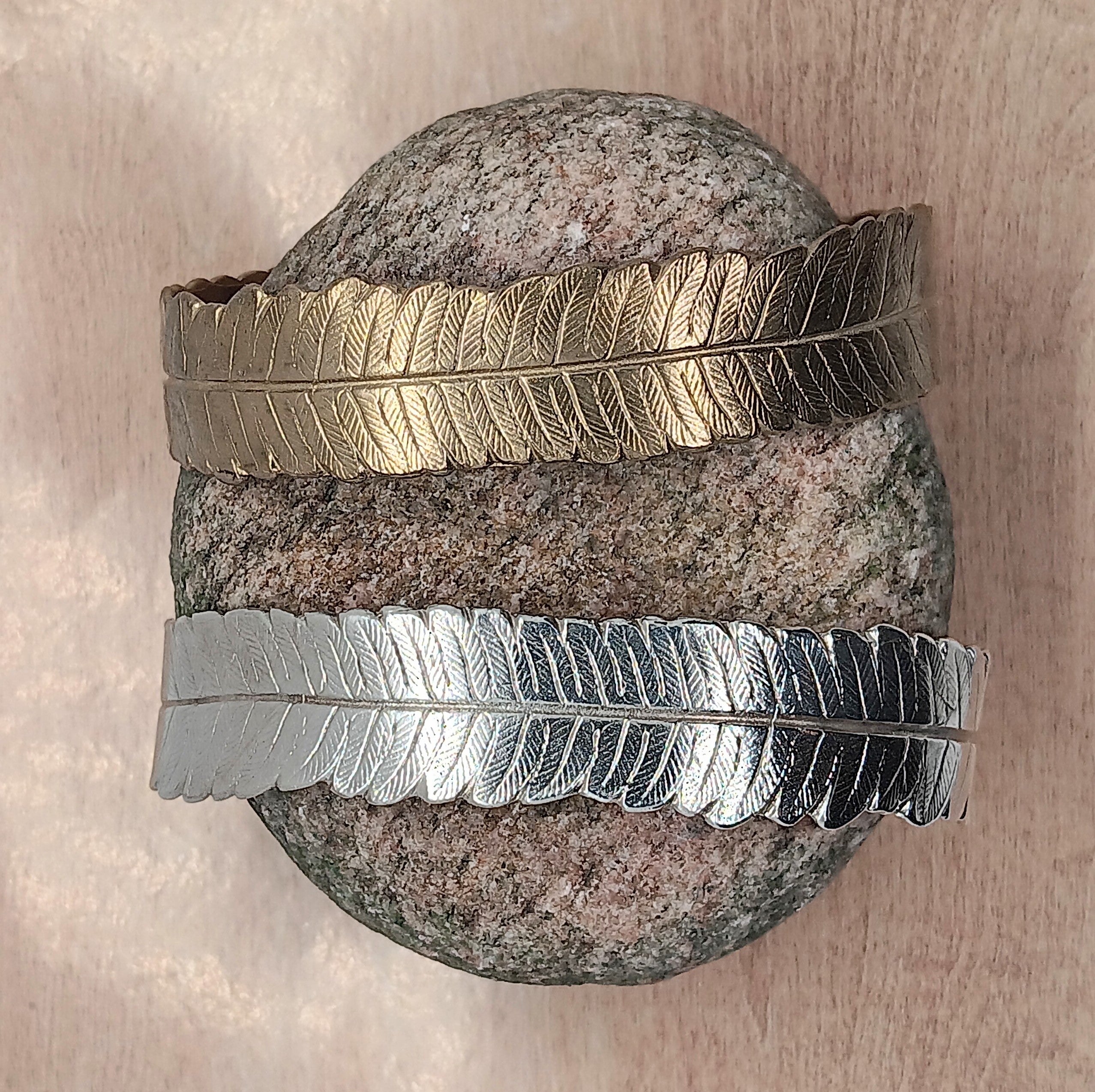 delicate veins of the fern leaf are visible on a life sized sterling silver or bronze bangles cast from mother nature