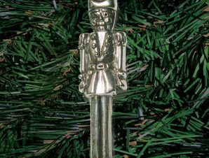 Finely detailed nutcracker doll stands at attention (small-palm sized, single-sided)