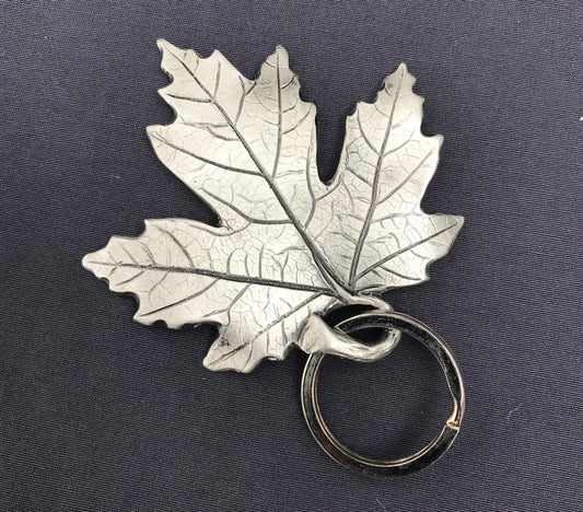 close up of handcrafted pewter maple leaf showing vein and rib detailing with key ring option