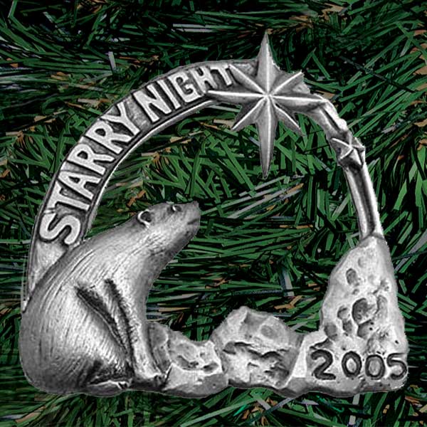 Finely detailed polar bear sits on ice bearing the year 2005 to gaze up at a star resembling the Star of Bethlehem on an arch that reads “starry night”. Hand carved then die-cast in pewter (palm sized, single-sided)