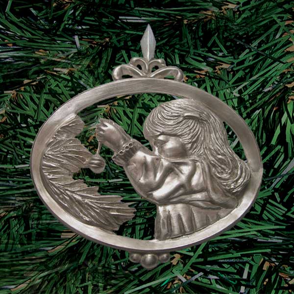 Finely detailed close-up of a young person with long hair reaching to hang an ornament on a tree branch (palm sized oval, single-sided die-cast pewter)