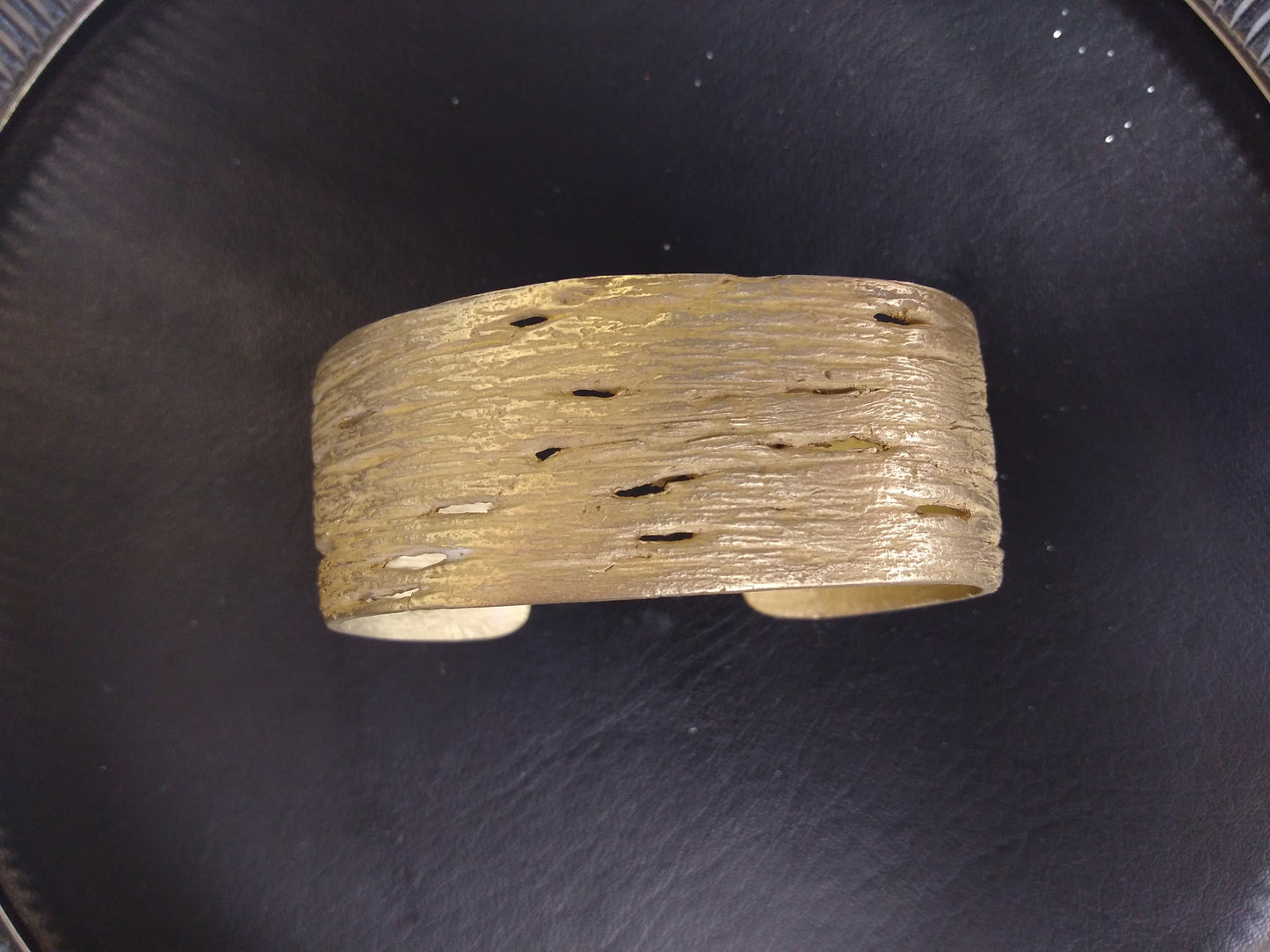 Birch bark striations and <meta charset="utf-8">horizontal pores (lenticels) are visible on this finely crafted bronze bangle cast from nature
