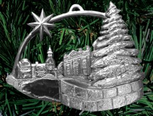 A palm-sized pewter holiday ornament featuring a prominent Christmas tree and shining star in the Market Square at city hall in Kingston, Ontario
