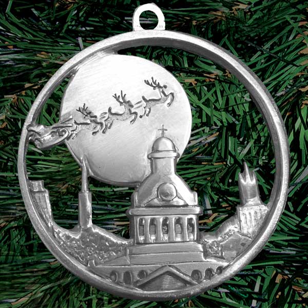 Finely detailed scene of a team of reindeer pulling Santa’s sleigh skyward in front of the Moon, over Kingston’s iconic skyline (palm sized, single-sided round, die-cast pewter)